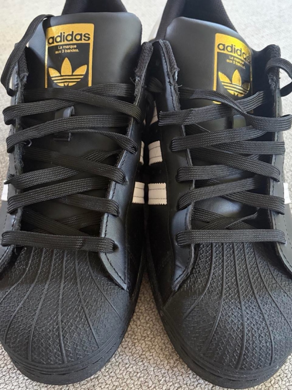 adidas Superstar Men's Sneakers in Black with White Stripes and Gold Accents